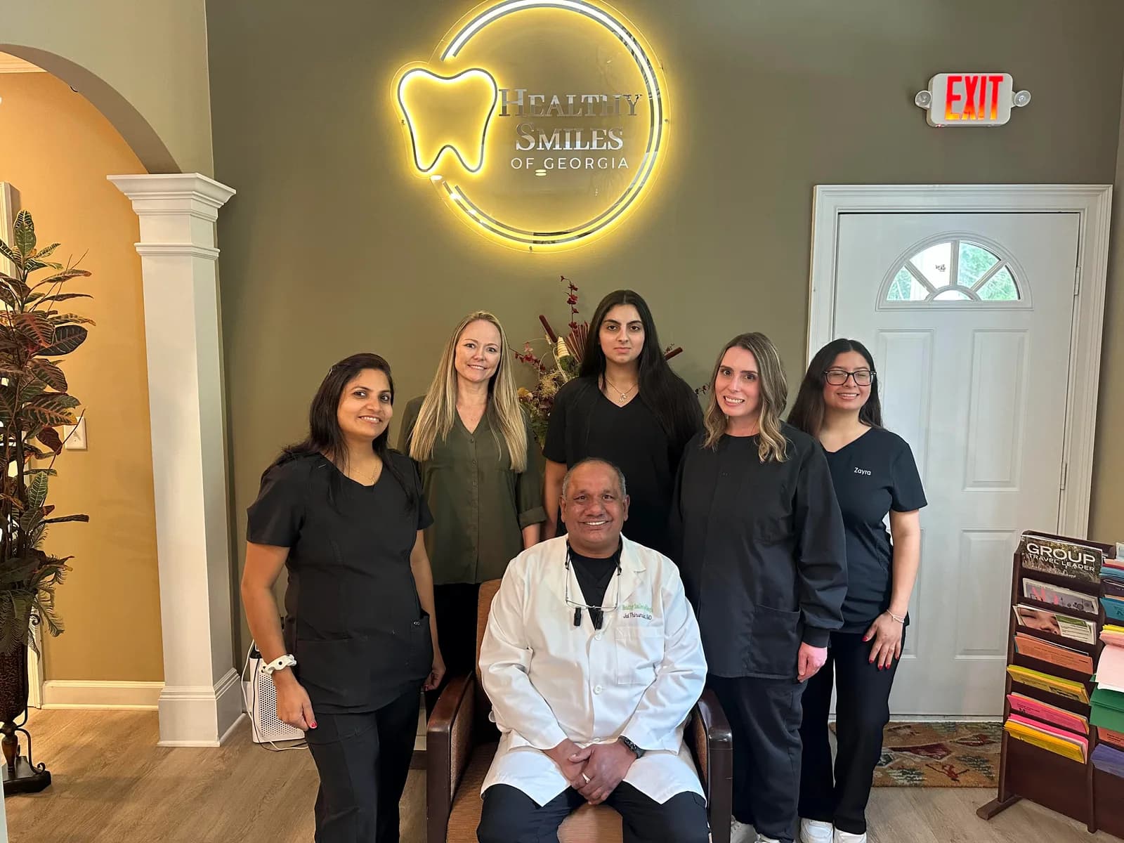 The Healthy Smiles of Georgia team with Dr. Jai in the office lobby